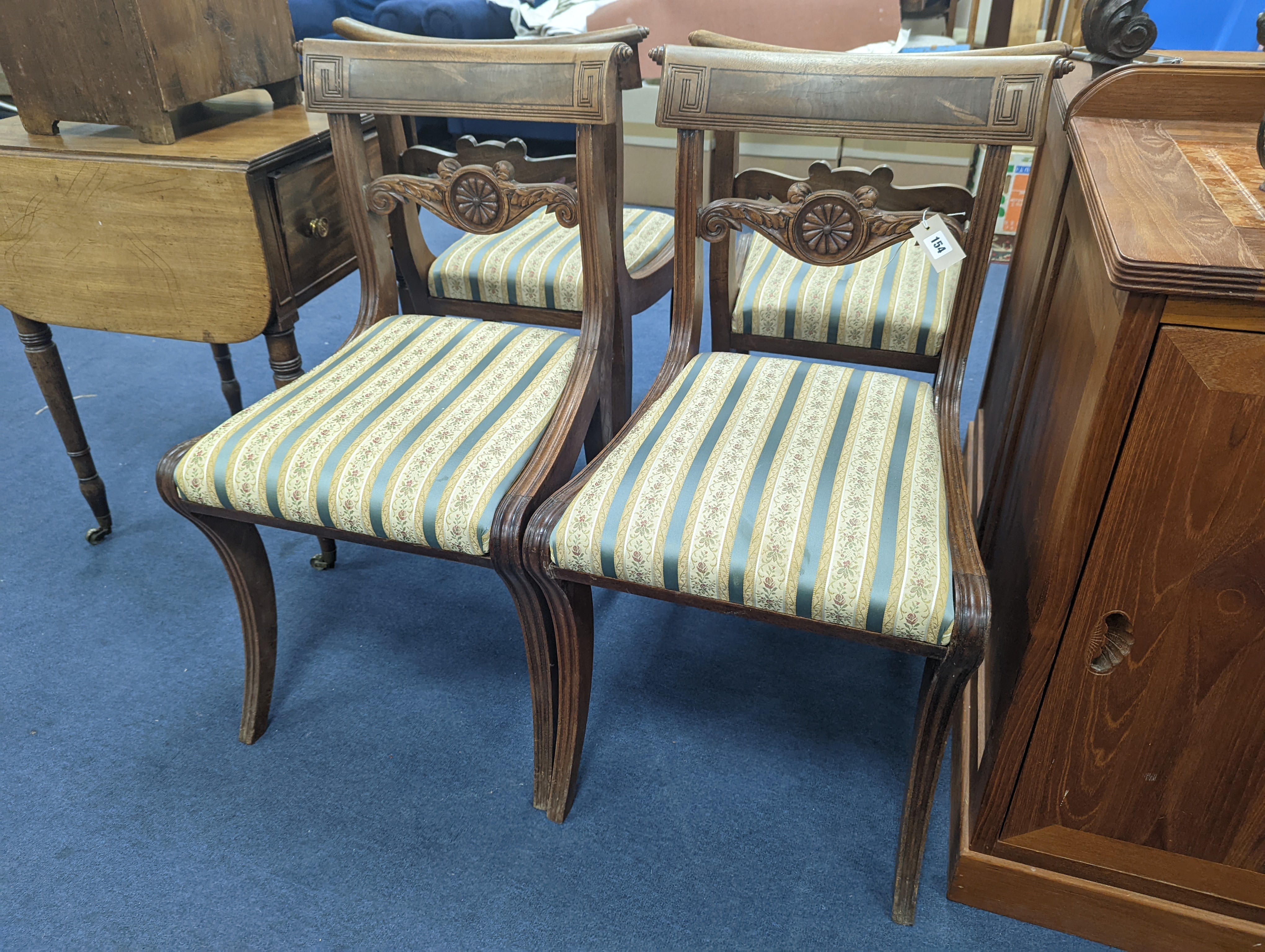 A set of six Regency mahogany dining chairs on sabre legs